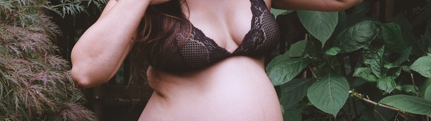 A woman wearing a black, padded nursing bra. Find maternity and nursing bras at Forty Winks
