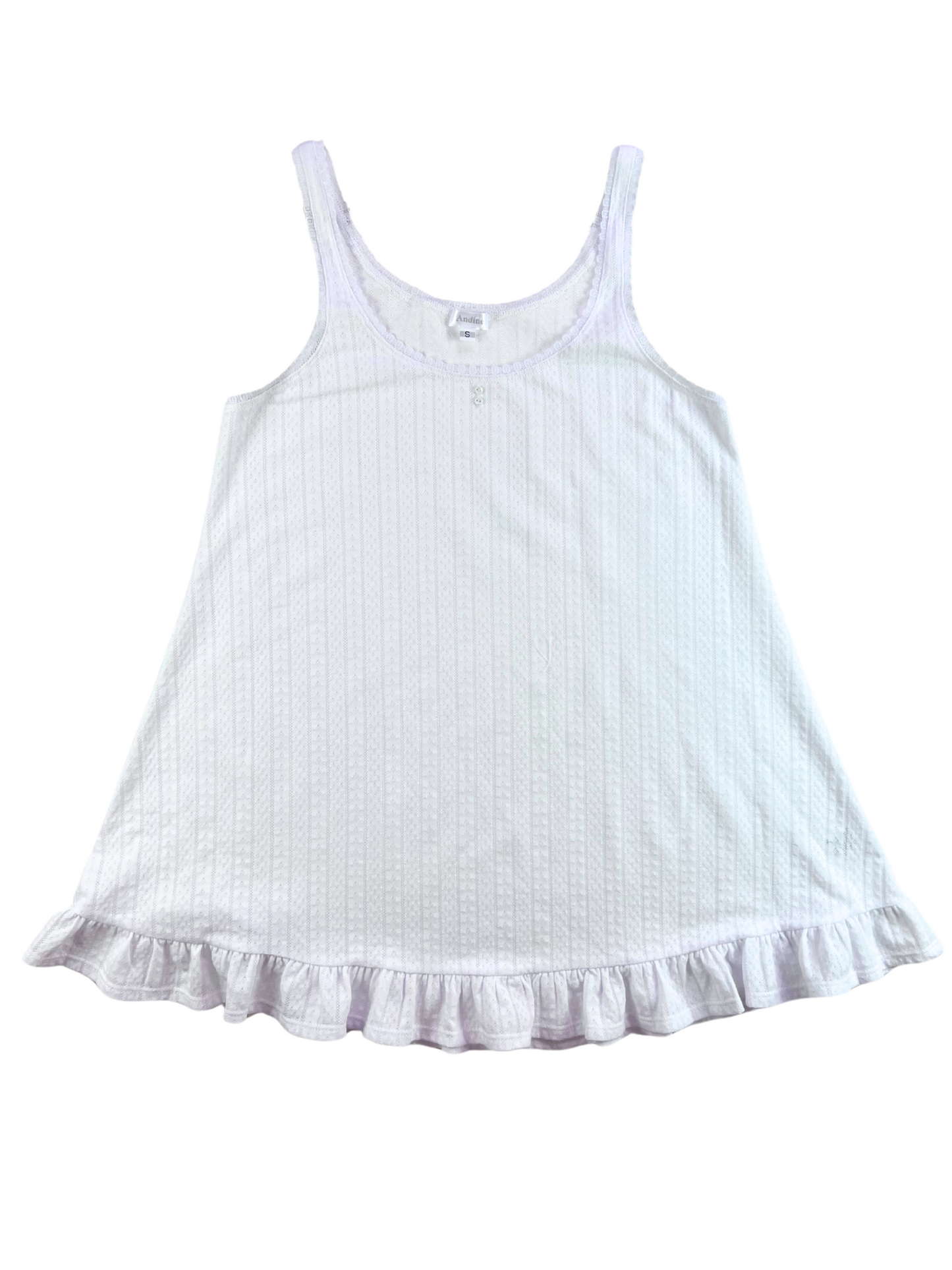 A white chemise with lace trim at the scoop neckline, button detailing, and a ruffle hem at the bottom.