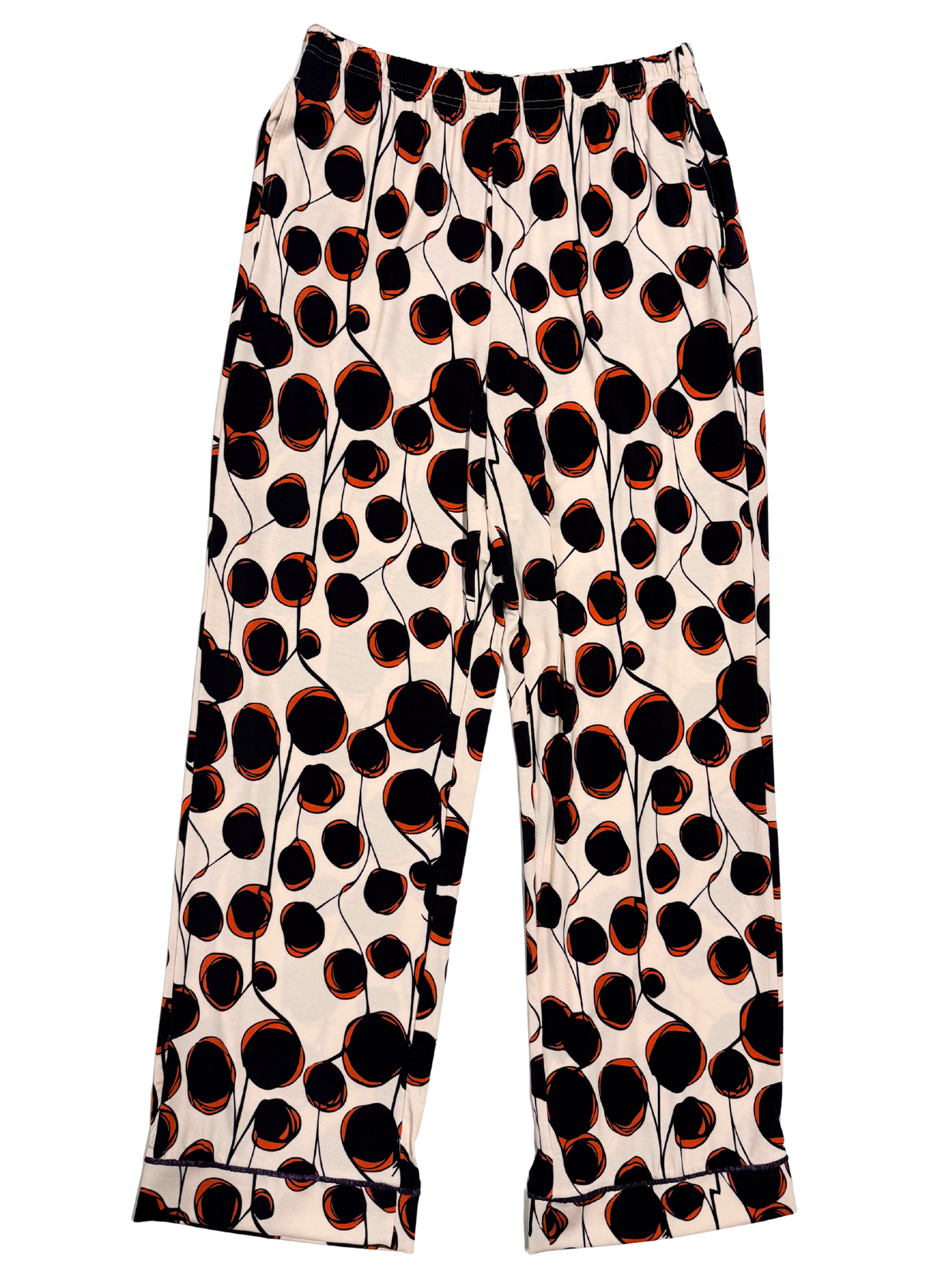 of white long pj bottoms with a black and coral abstract polkadot pattern laying flat against a white background.