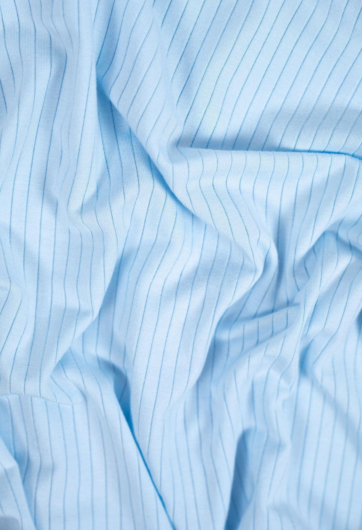 Close-up of light blue fabric with subtle stripes