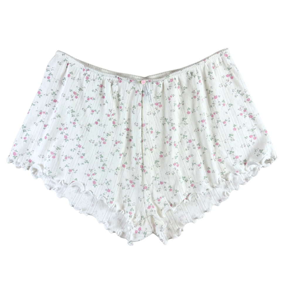 white floral shorts on a white background.