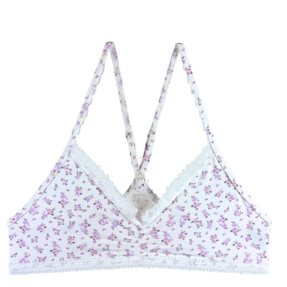 White underwire bra with a delicate purple and pink floral print, featuring lace trim and adjustable shoulder straps.