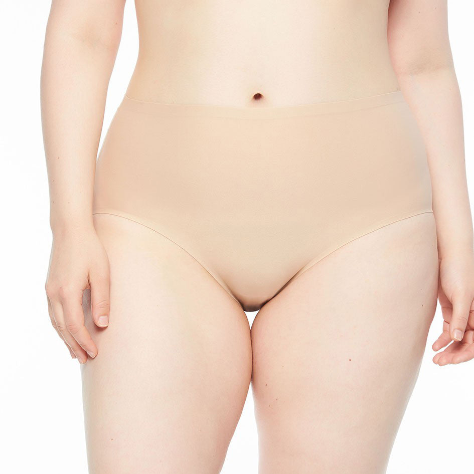person wearing beige underwear against a white background