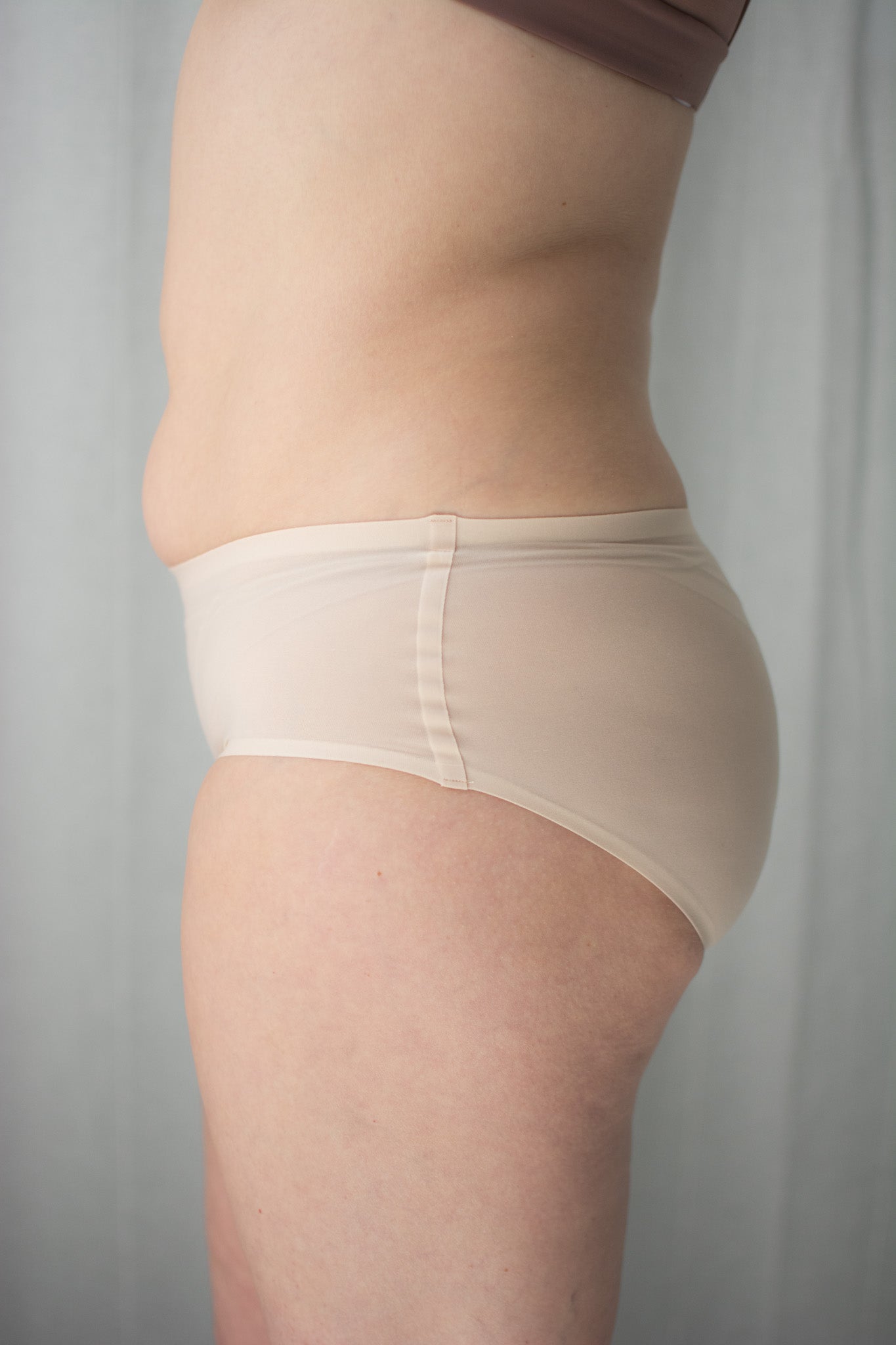 Beige shapewear worn by a person on a plain background