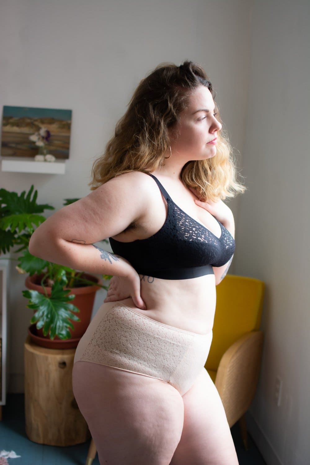 Chantelle norah high waist brief in nude blush, side view on a model, full-body, standing at an angle.
