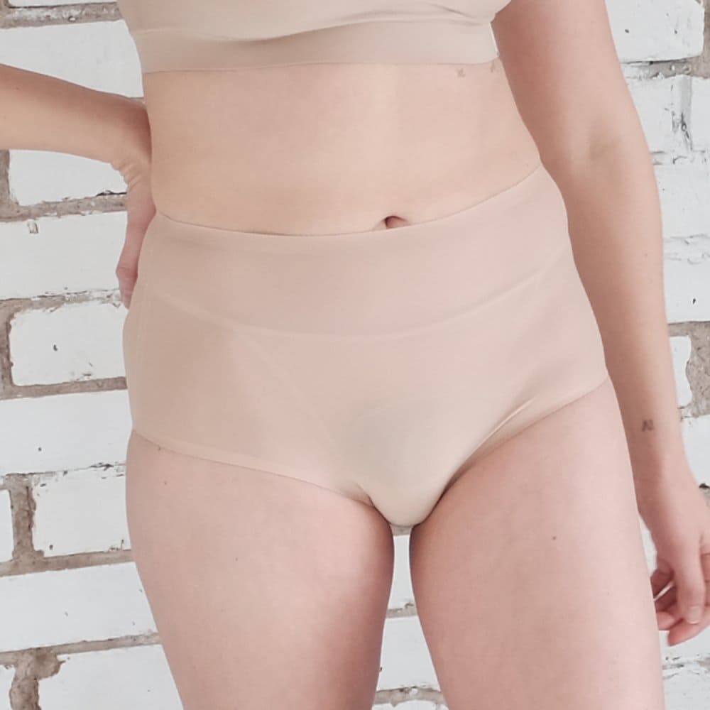 Chantelle soft stretch high rise brief in ultra nude, front view on a model, close-up.