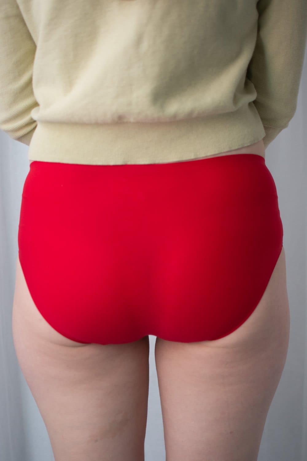 Chantelle soft stretch hipster in poppy red, back close-up on a model.