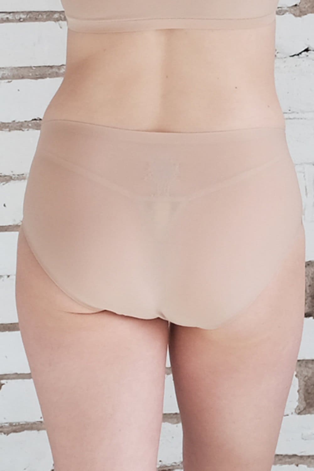 Chantelle soft stretch hipster in ultra nude, back view on a model, close-up.