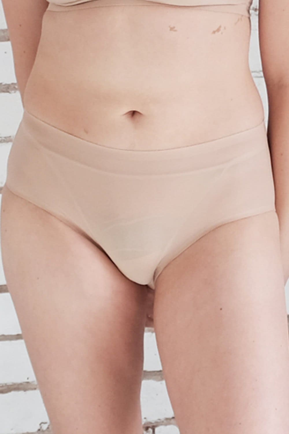 Chantelle soft stretch hipster in ultra nude, front view on a model, close-up.