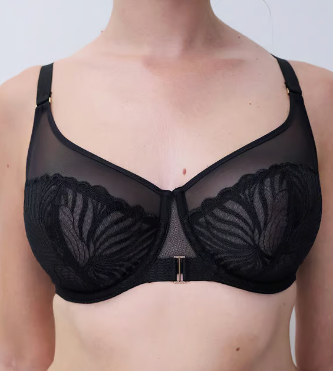 Black bra with floral details on a plain background