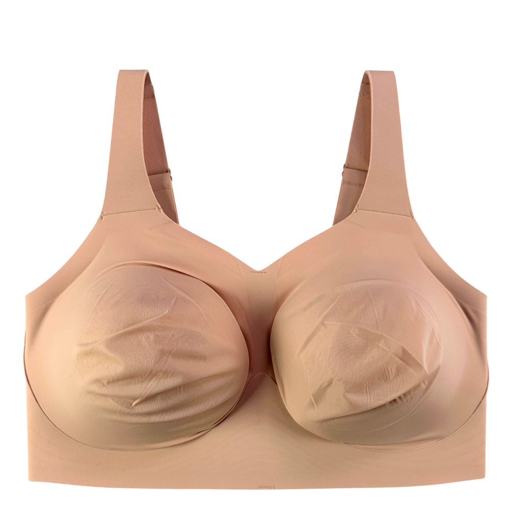 A seamless, wireless underwire bra in a light peach-beige color, featuring molded cups and adjustable shoulder straps, shown against a plain white background.