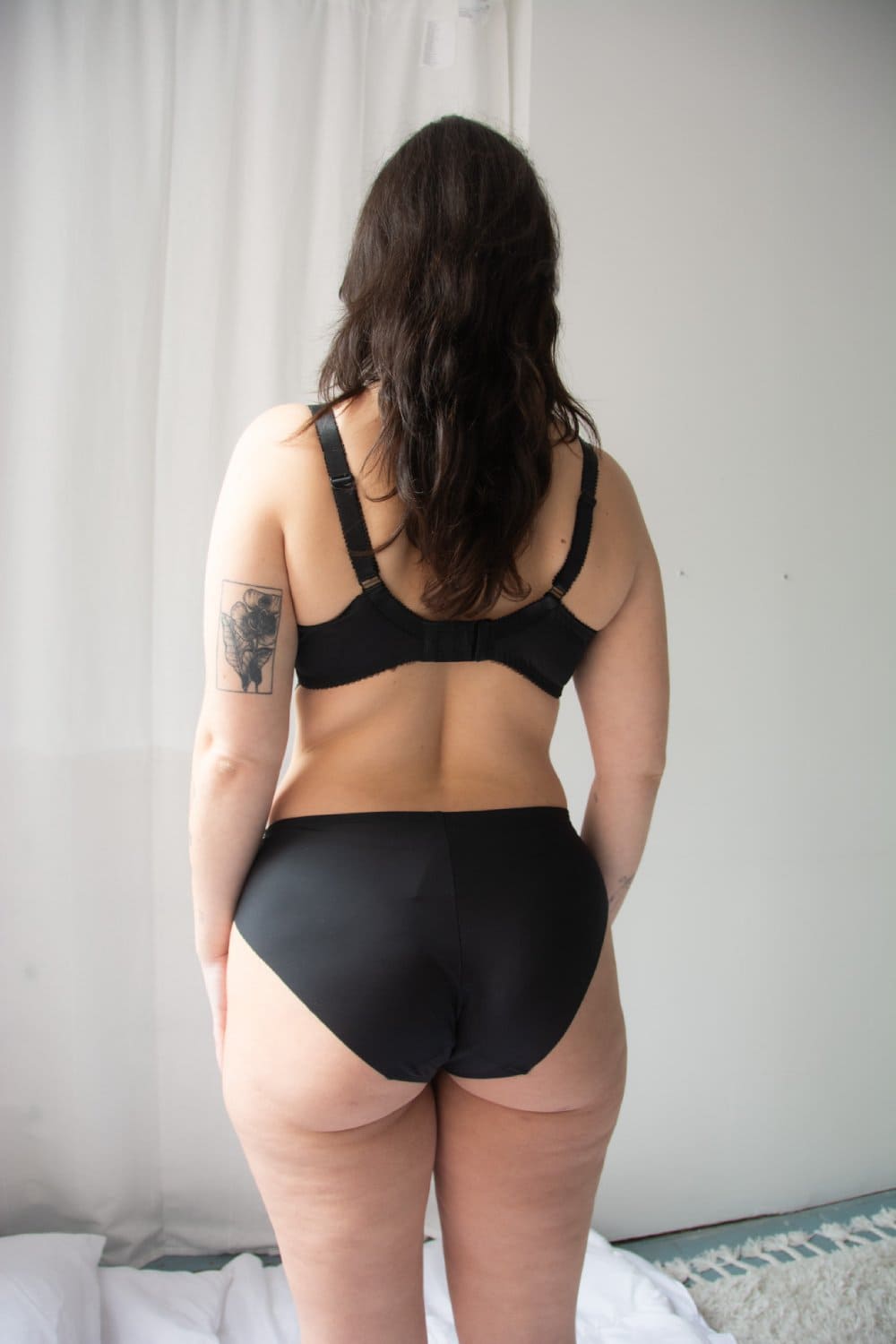 Fantasie emmaline side support bra in midnight on a model back view.