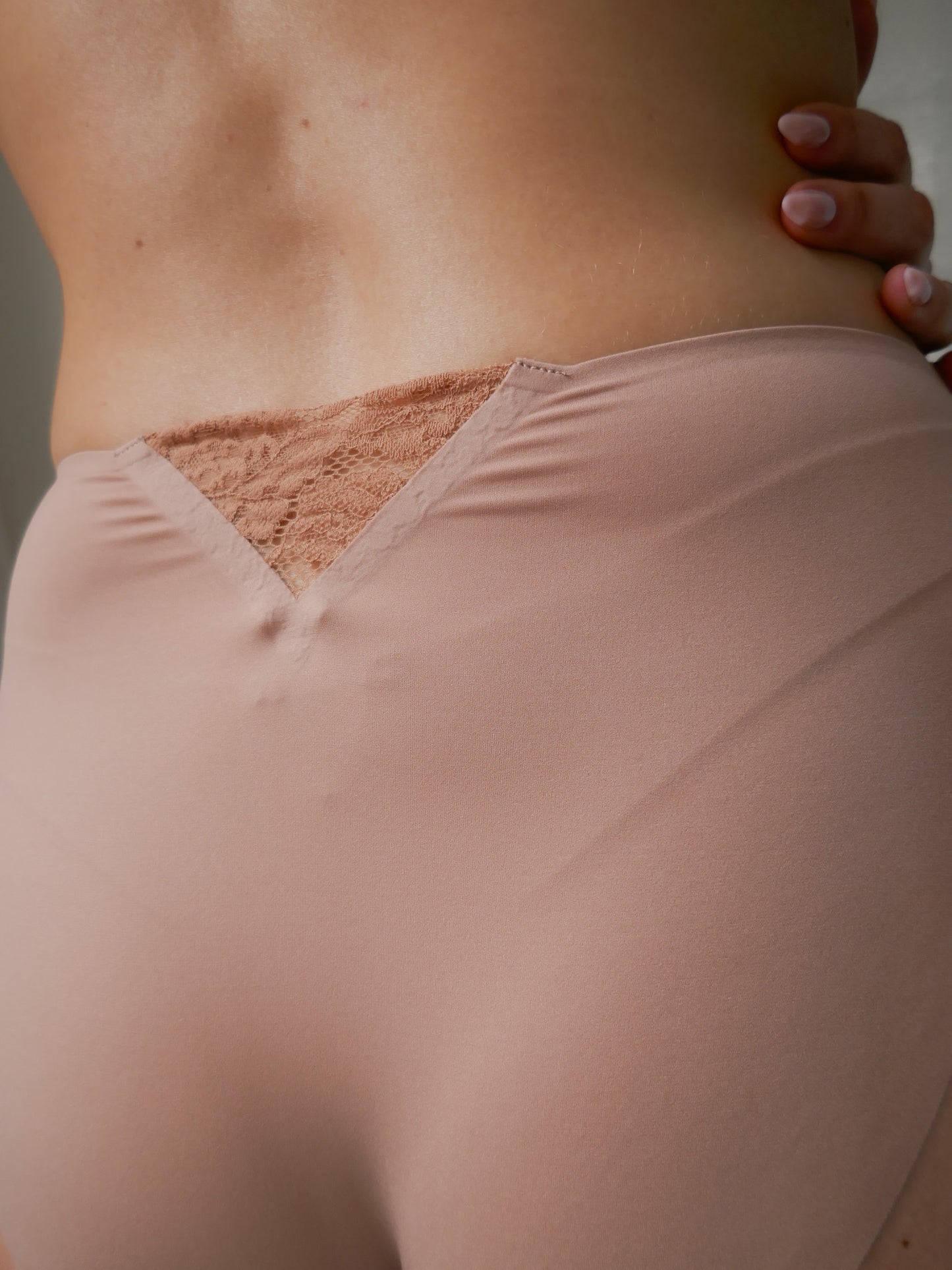 Person wearing tan high waist underwear.