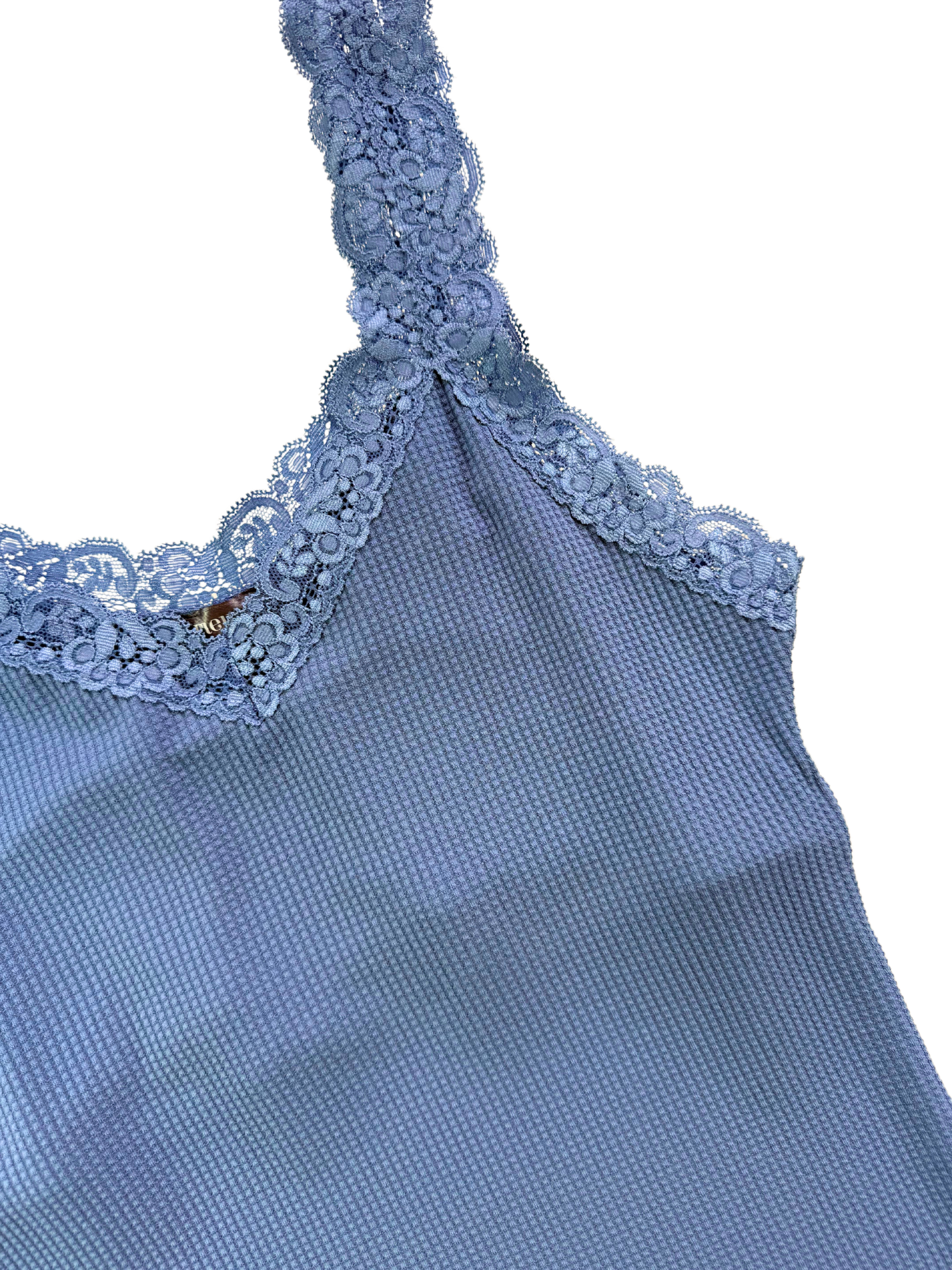 Blue sleeveless top with lace detailing on a white background