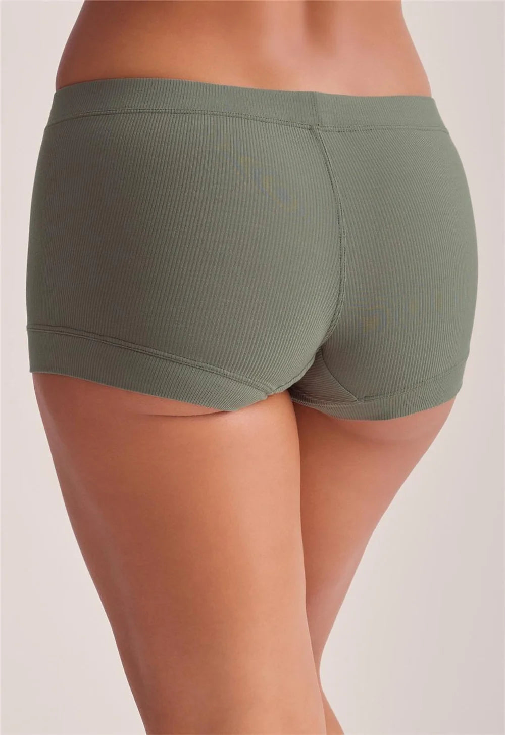 green ribbed boxer shorts on a model against a white background.