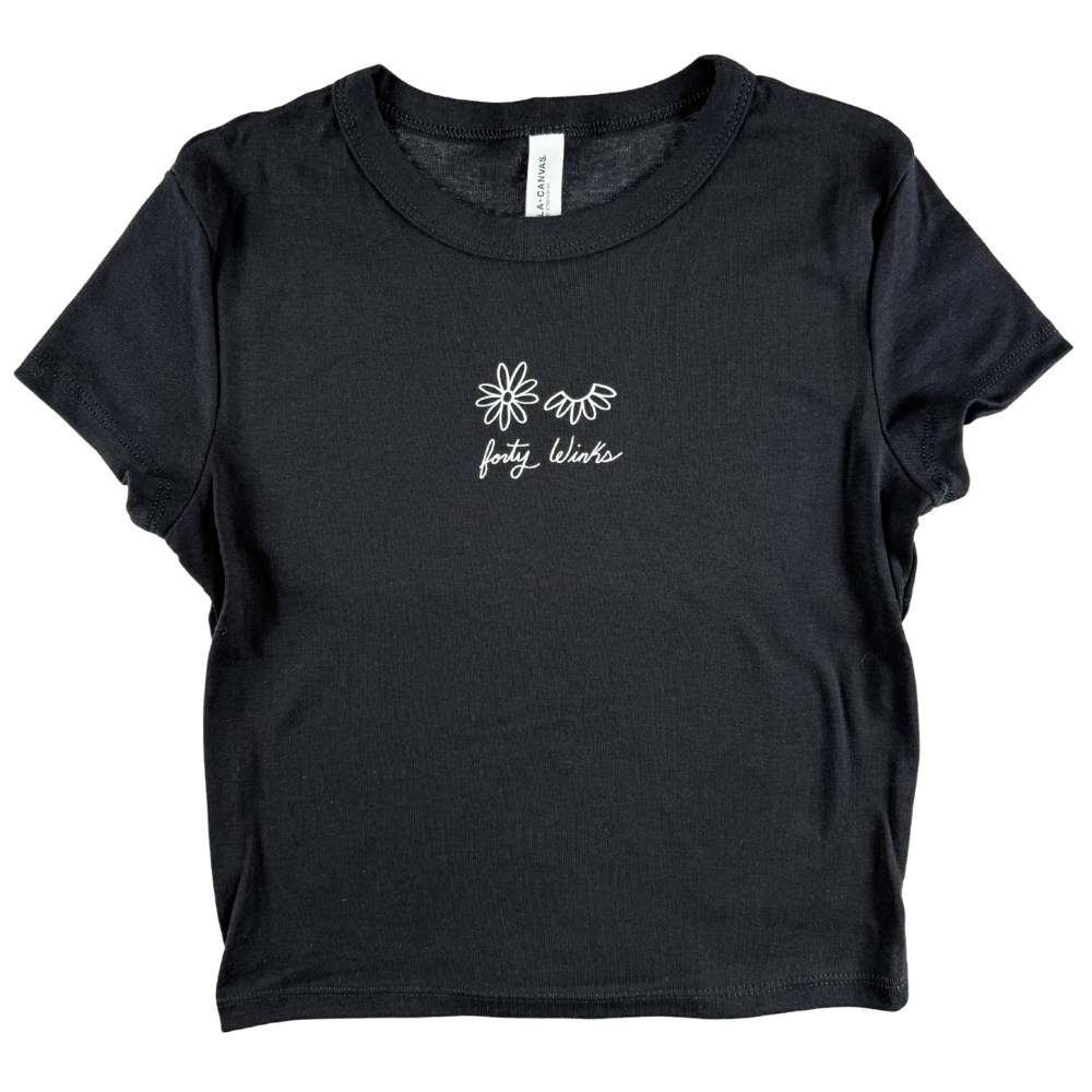 Black t-shirt with white floral design and text on a white background