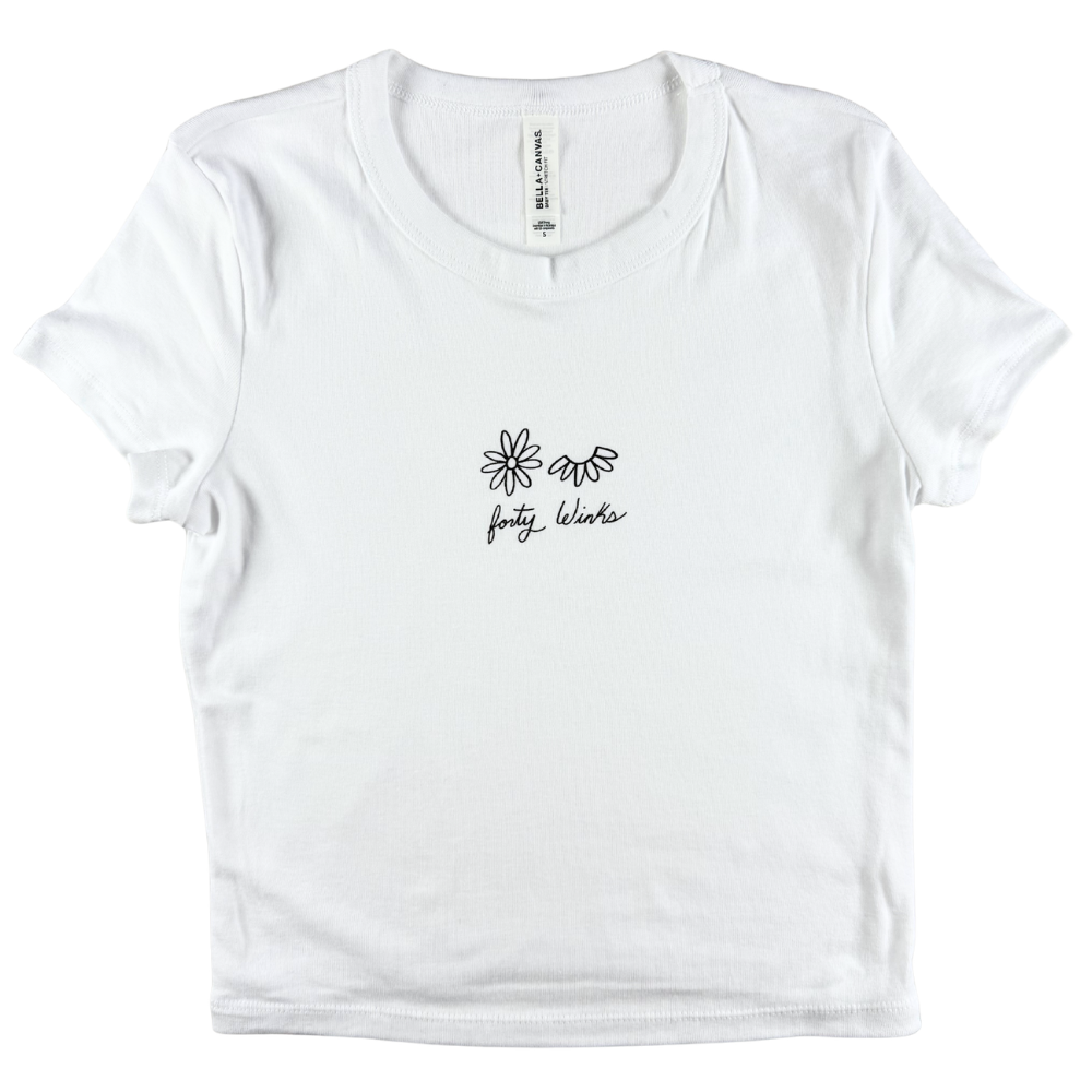 White t-shirt with black floral design and text on a white background
