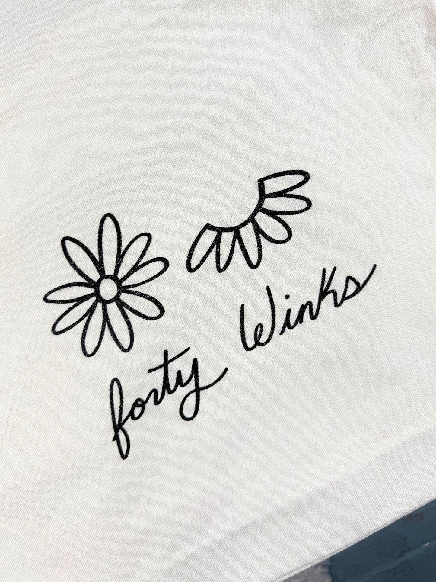 Black floral designs and 'forty winks' text on a white background