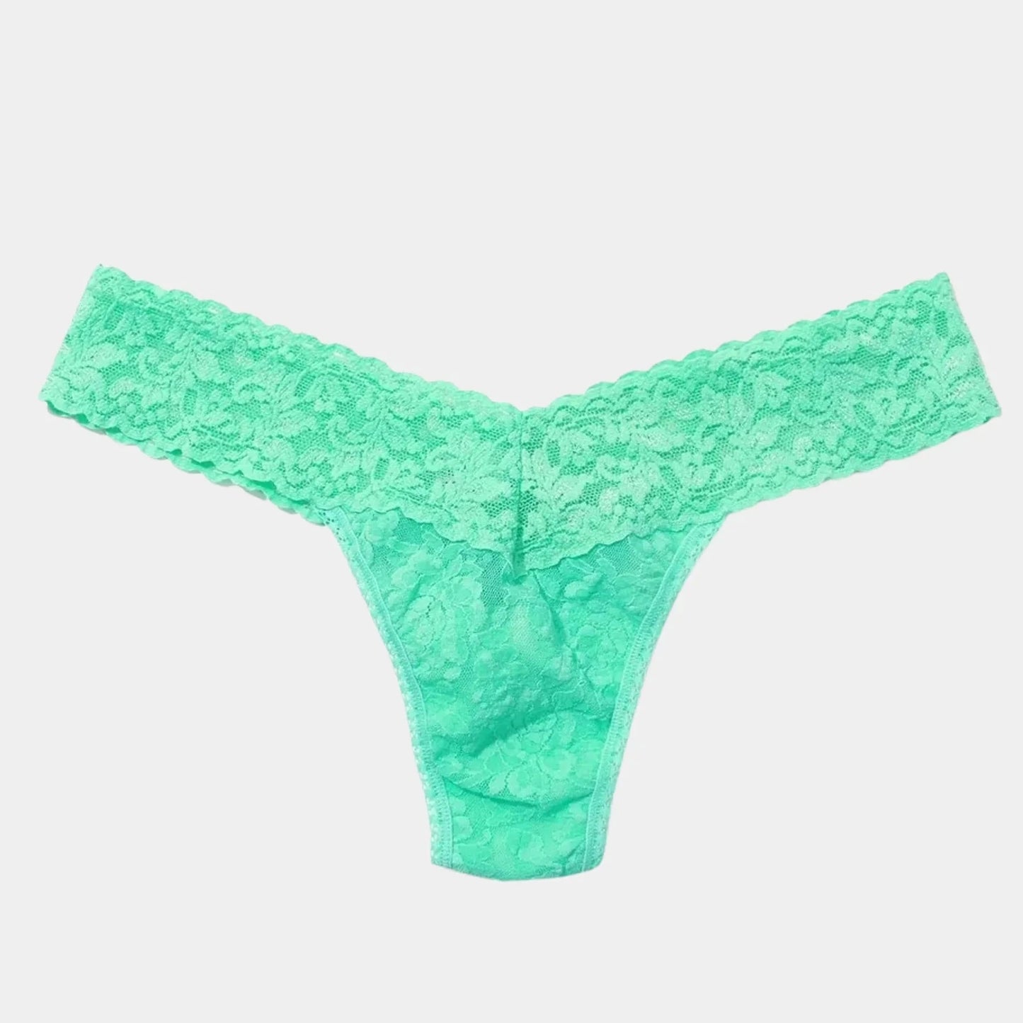 Green lace thong on a light gray background
