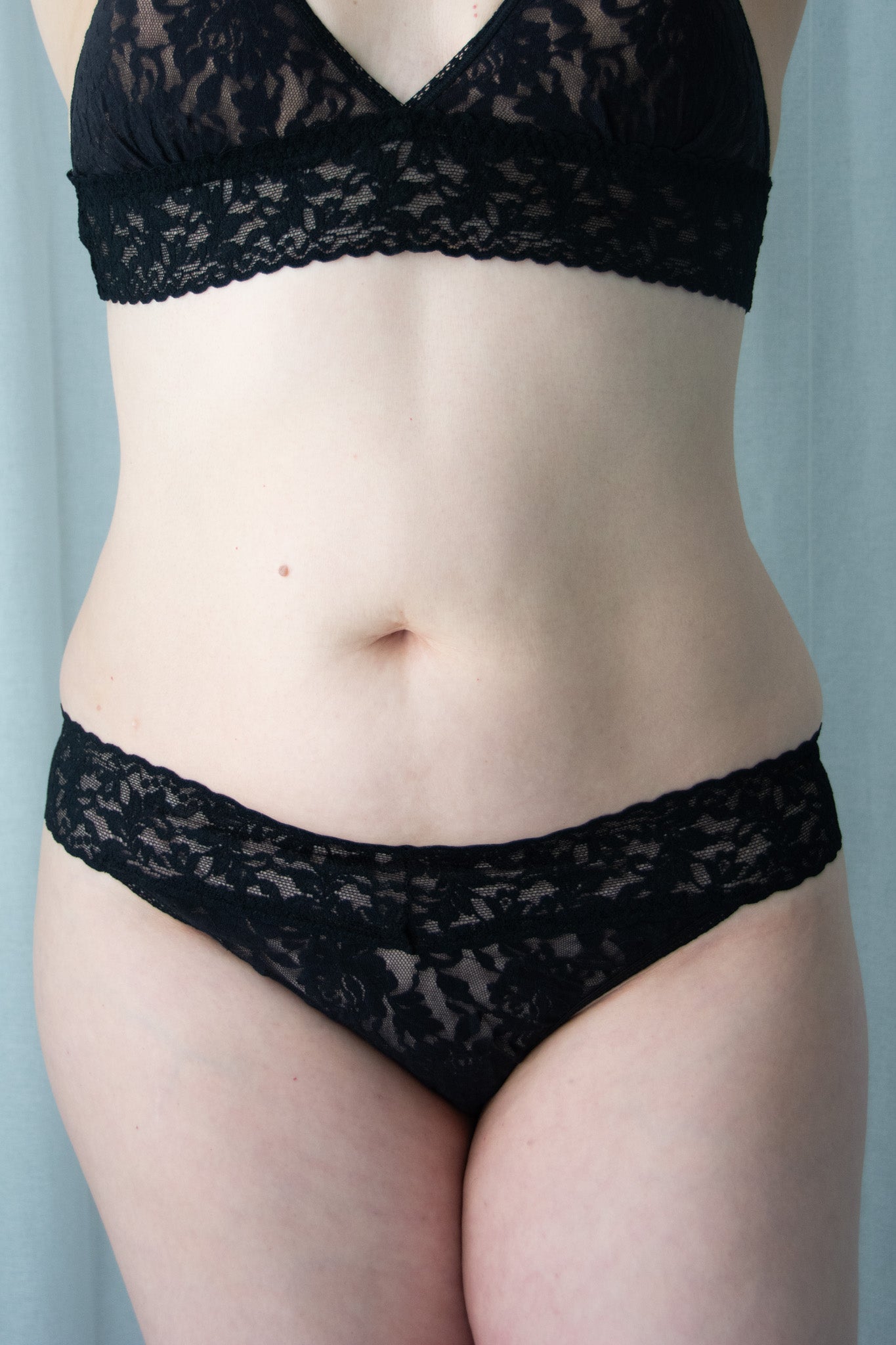 Black lace lingerie set on a neutral background