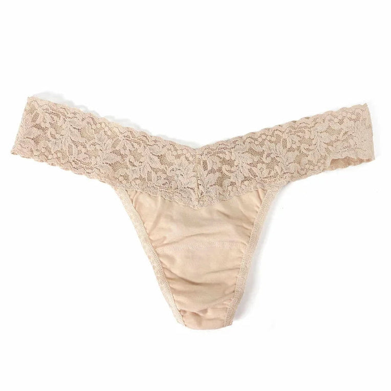 beige lace underwear against a white background