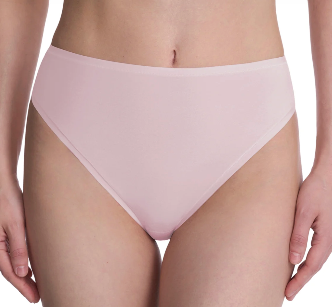 A close-up of a model wearing a light pink high-waisted brief or bikini-style bottom against a plain white background.