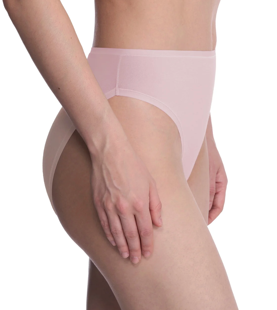 A close-up of a model wearing high-waisted, semi-sheer light pink briefs against a plain white background.