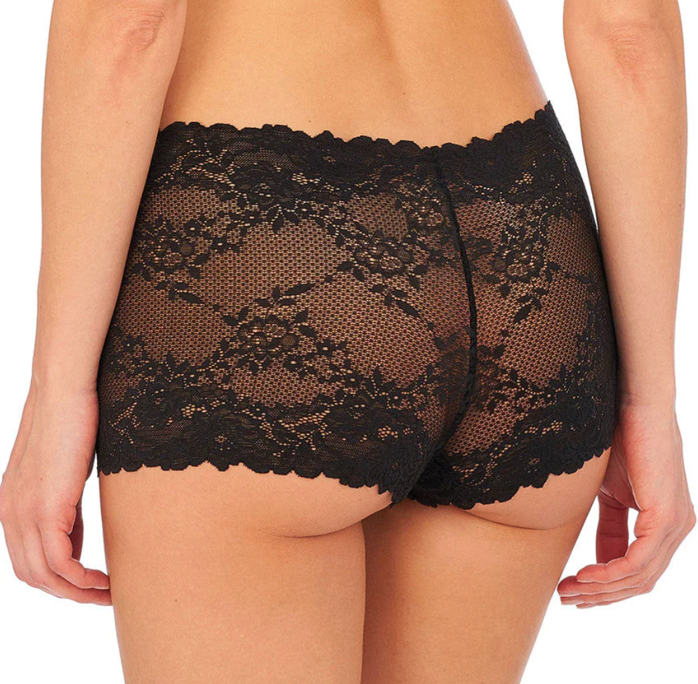 Rear view of a model wearing black lace high-waisted briefs against a plain white background.