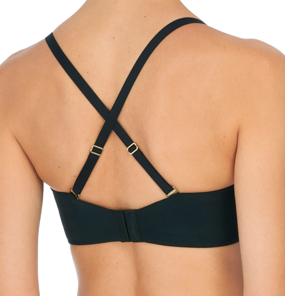 Person wearing black bra against a neutral background