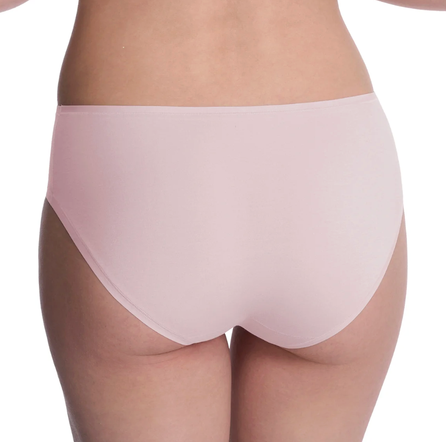 Rear view of a model wearing light pink seamless underwear against a white background.