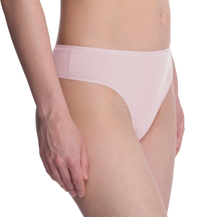 A close-up of a model wearing a light pink seamless high-waisted brief, showing the front and side views against a plain white background.