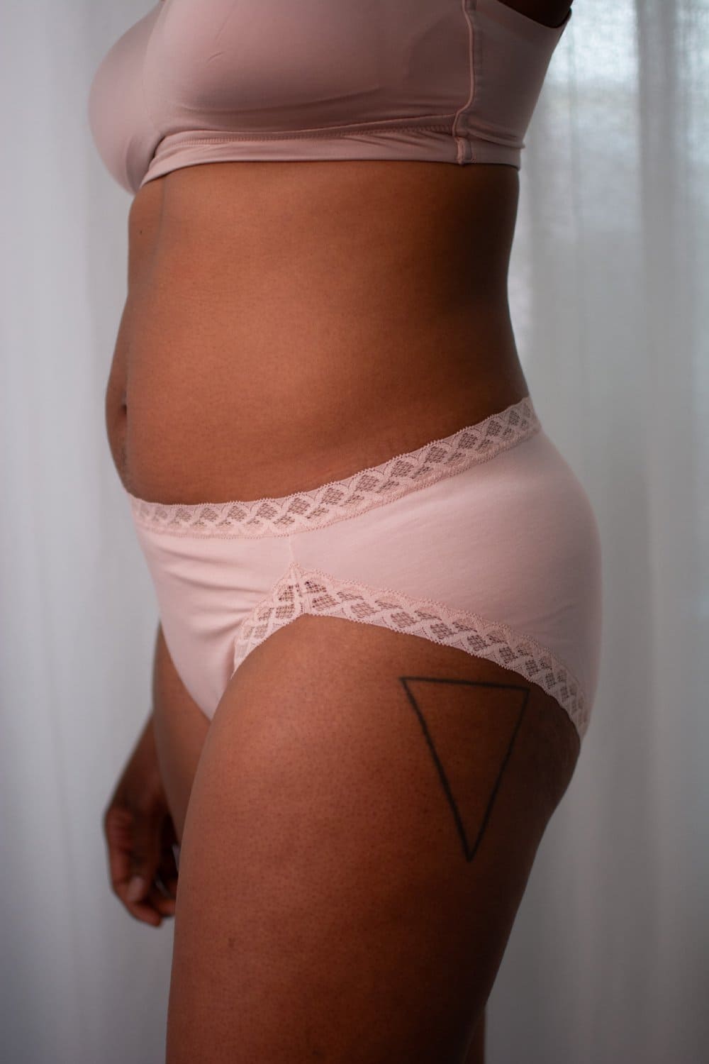 Natori bliss french cut brief in rose beige, side view on a model, close-up.