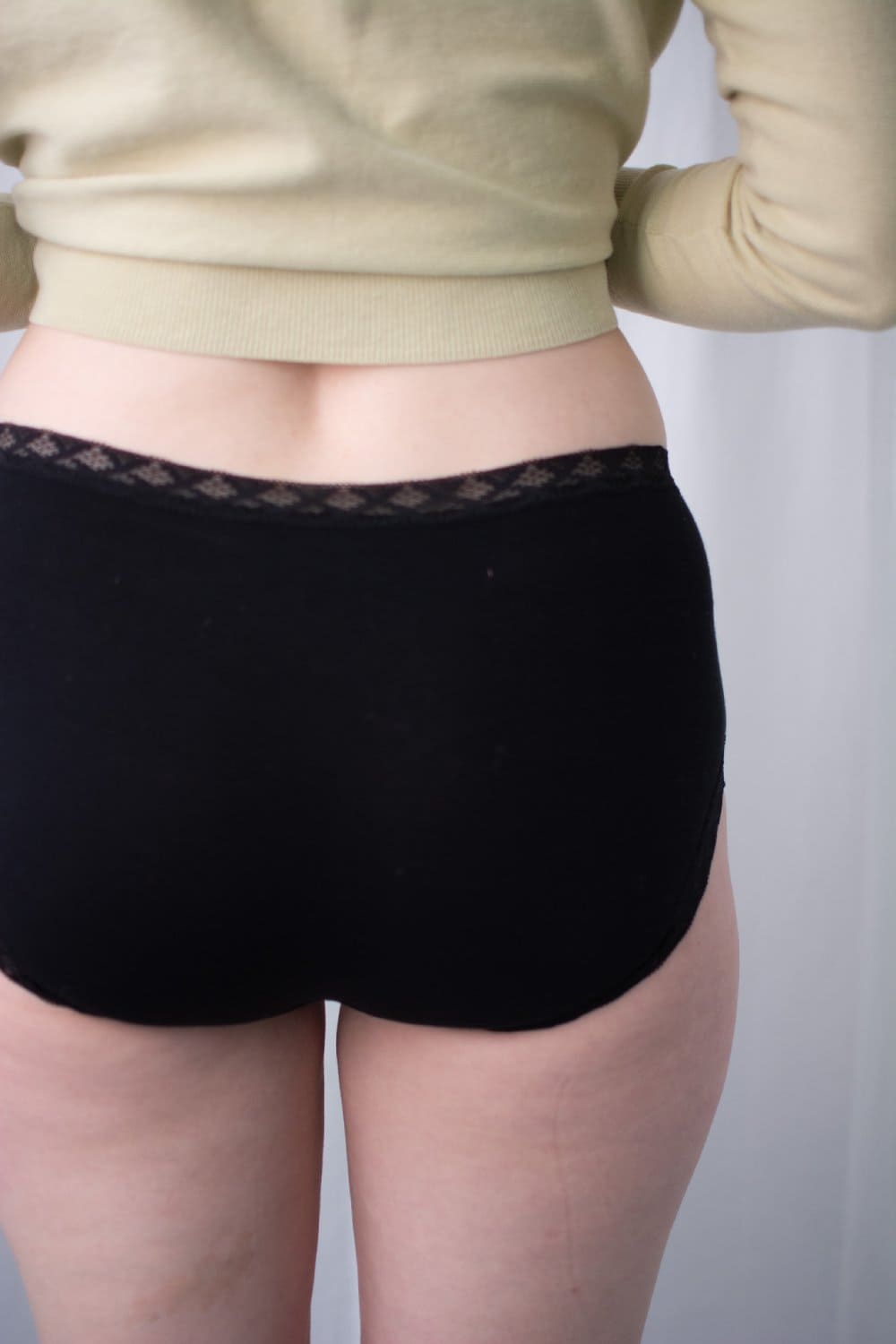 Natori Bliss full brief in black, back view on a model, close-up.