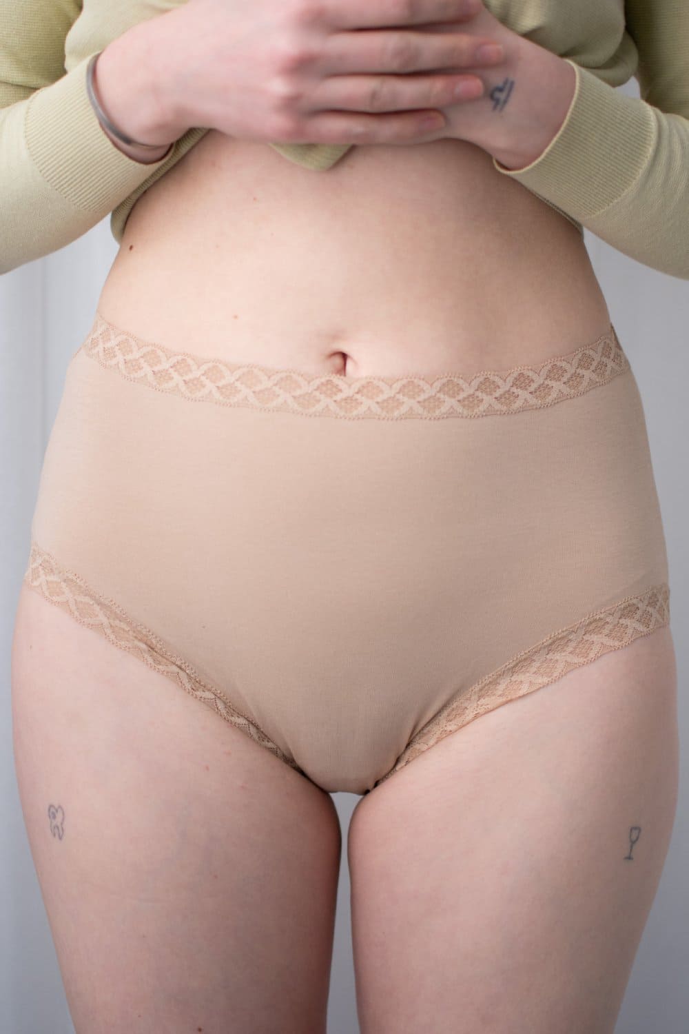 Natori Bliss full brief in cafe, front view on a model, close-up.