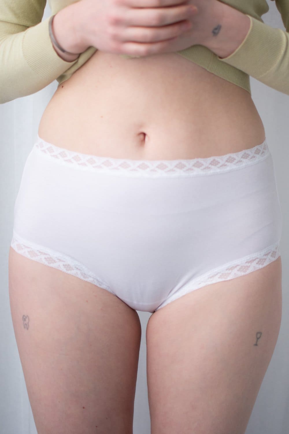 Natori Bliss full brief in white, front view on a model, close-up.