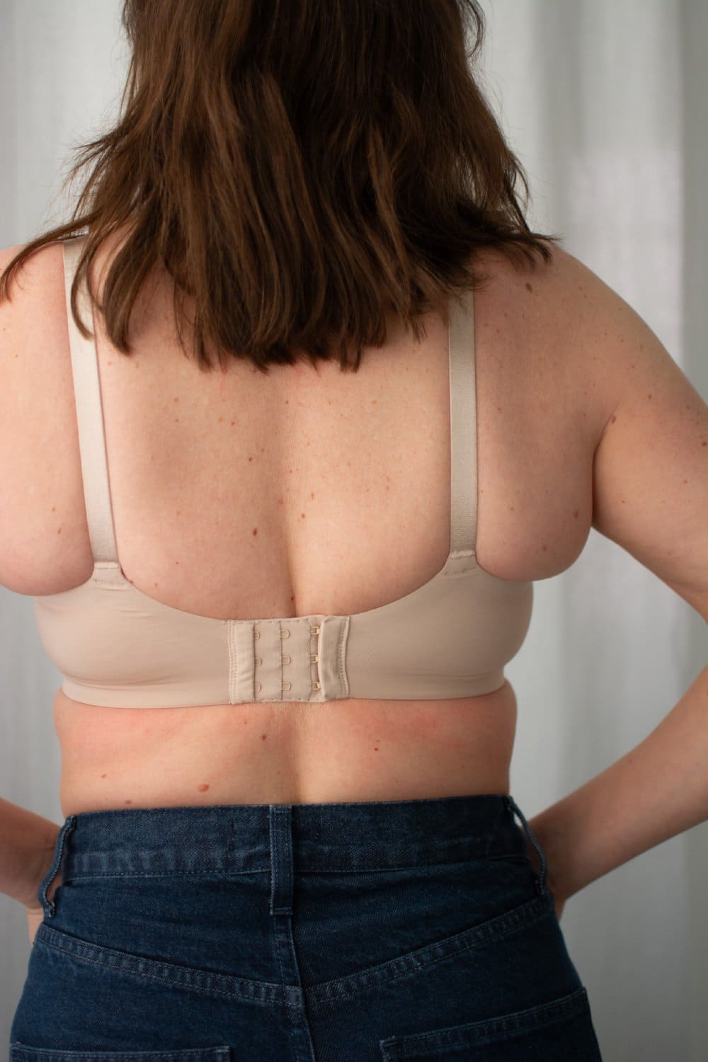 Natori Liquid full fit contour underwire bra in light mocha, close-up back view on a model.