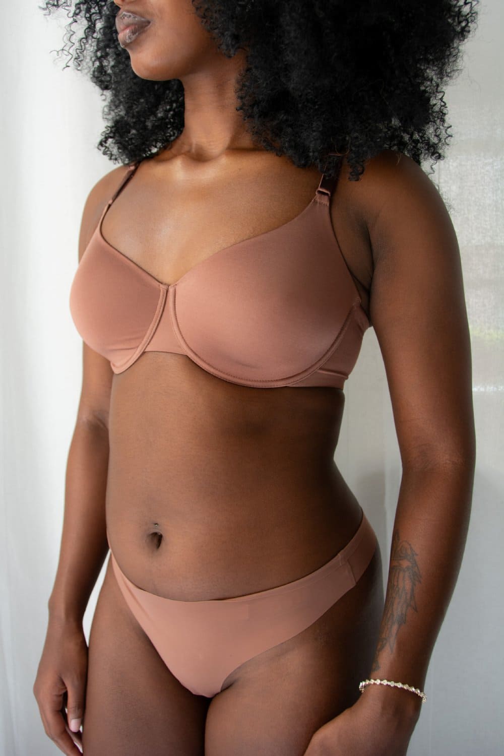 Natori Liquid full fit contour underwire bra in light nutmeg, close-up side front view on a model.