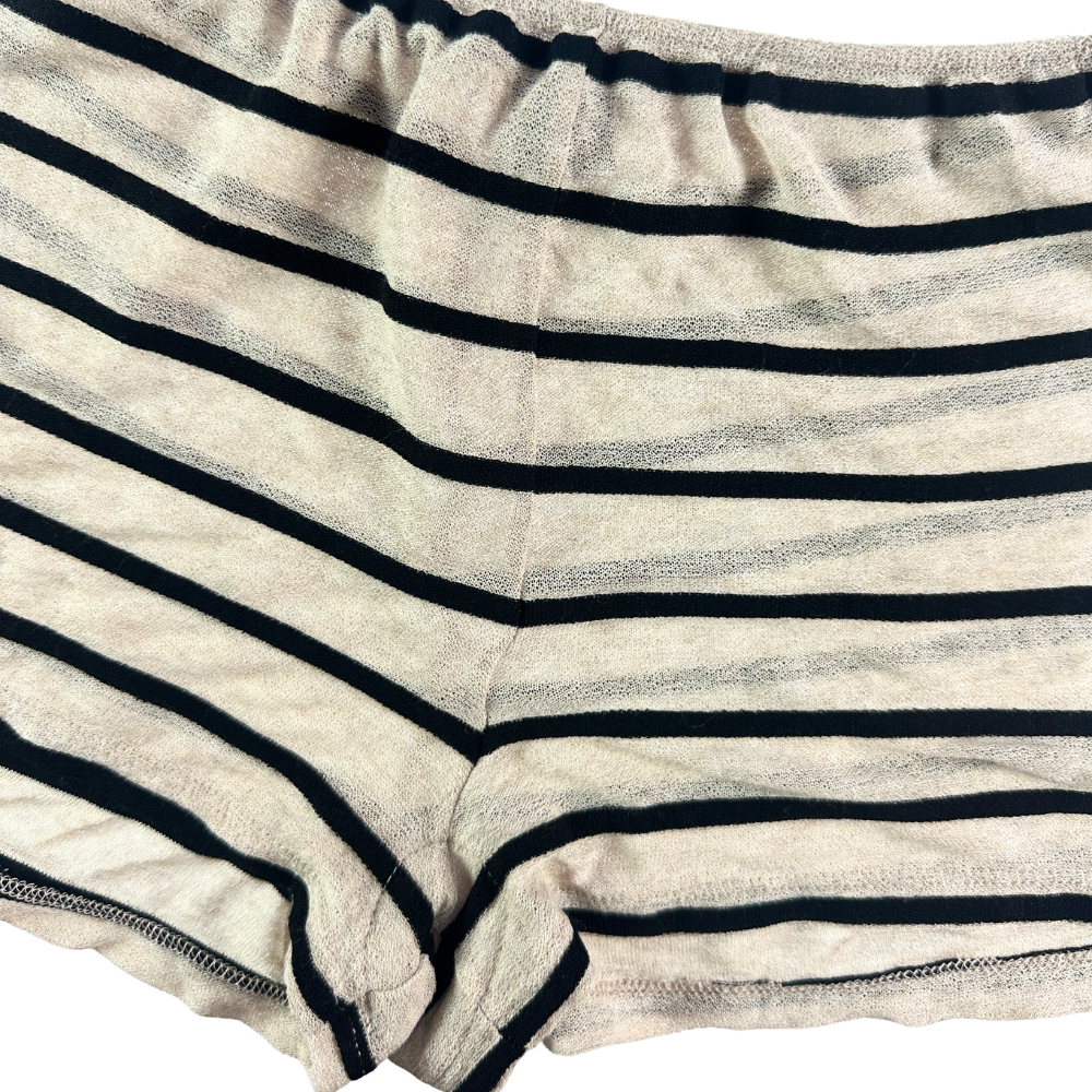 Close-up of striped underwear or boxer-brief style bottoms in a light beige or off-white fabric with dark navy horizontal stripes.