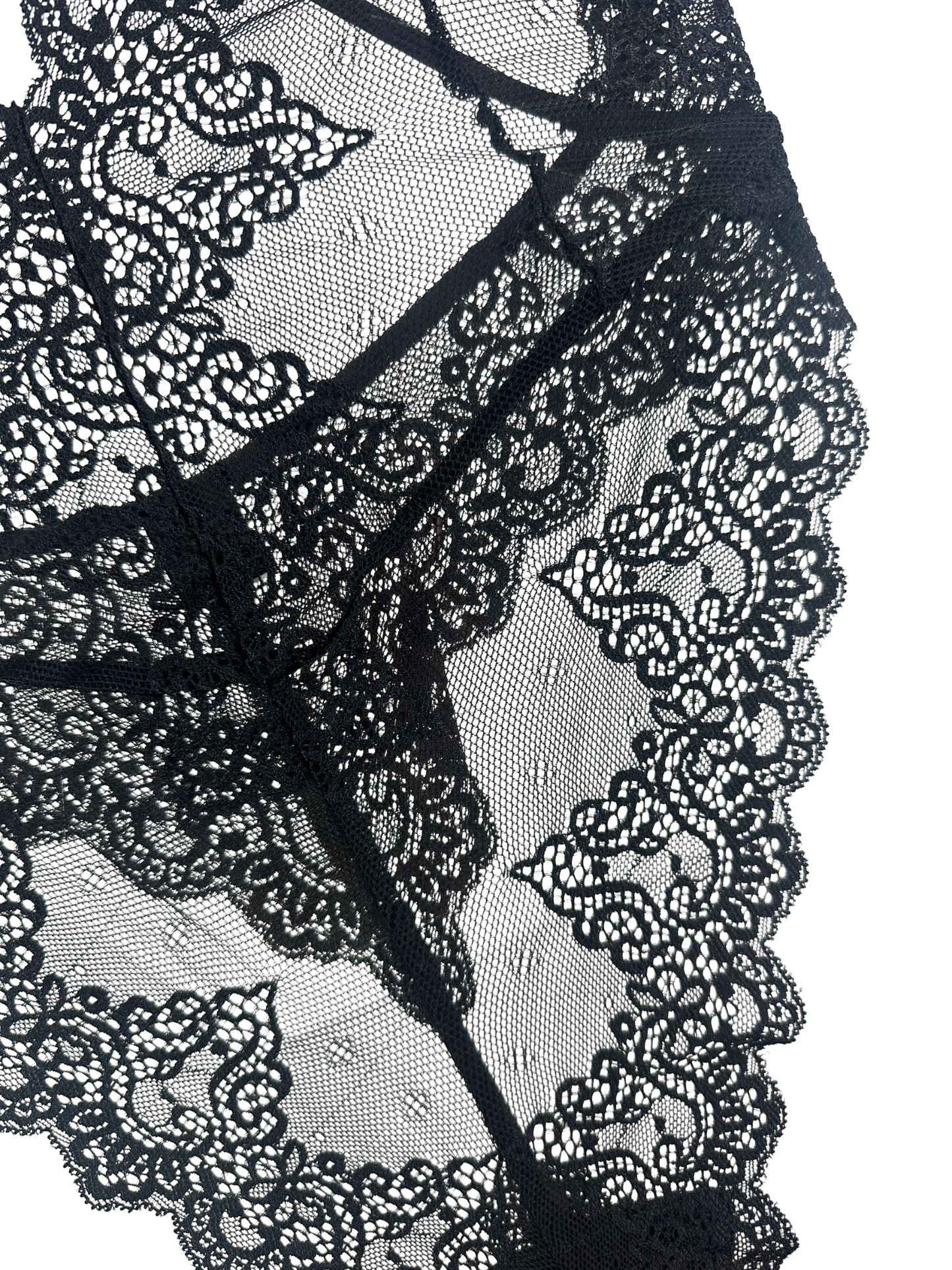 Black lace lingerie fabric with floral lace patterns and sheer mesh, shown in a close-up detail shot against a white background.