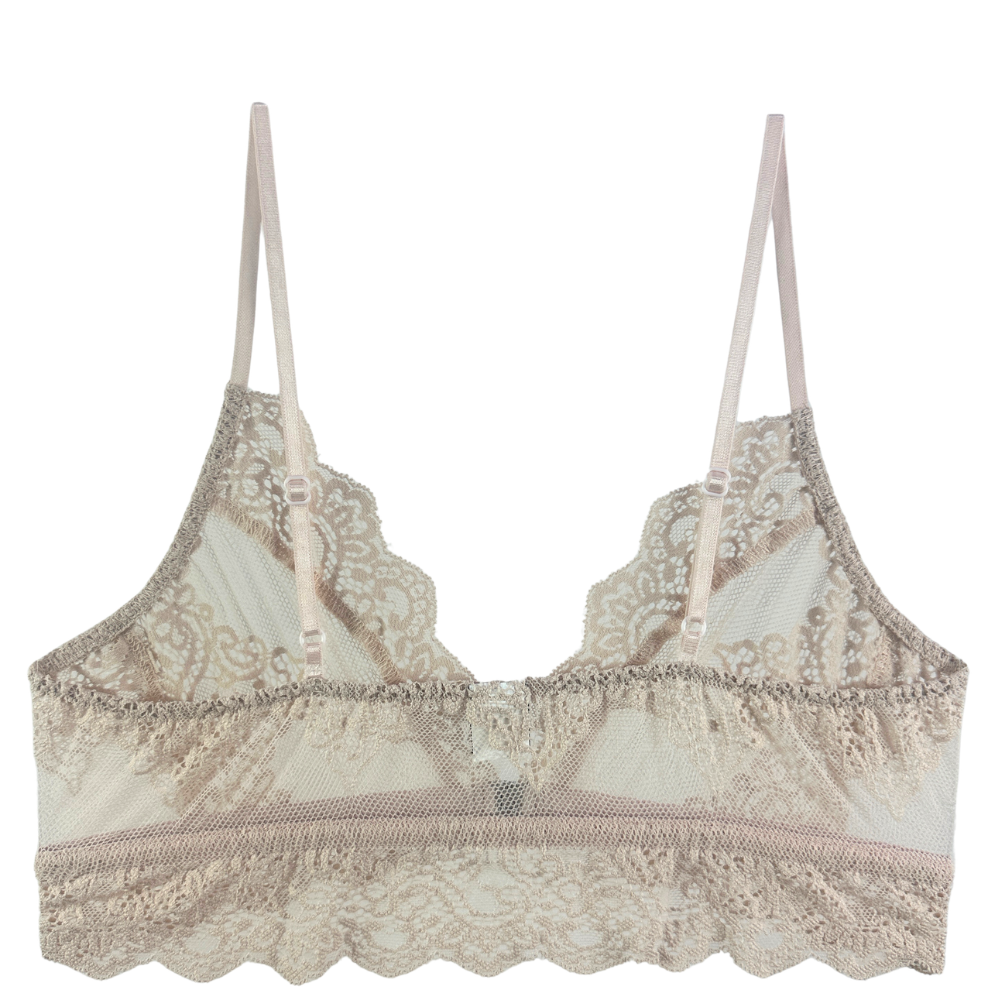 A beige lace bralette with thin adjustable straps, featuring intricate floral lace patterns, mesh cups, and a ruffled underband on a solid white background.