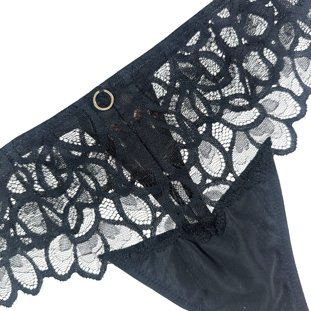 Black lace panties with a wide floral lace waistband and a small gold-tone ring detail, shown on a plain white background.