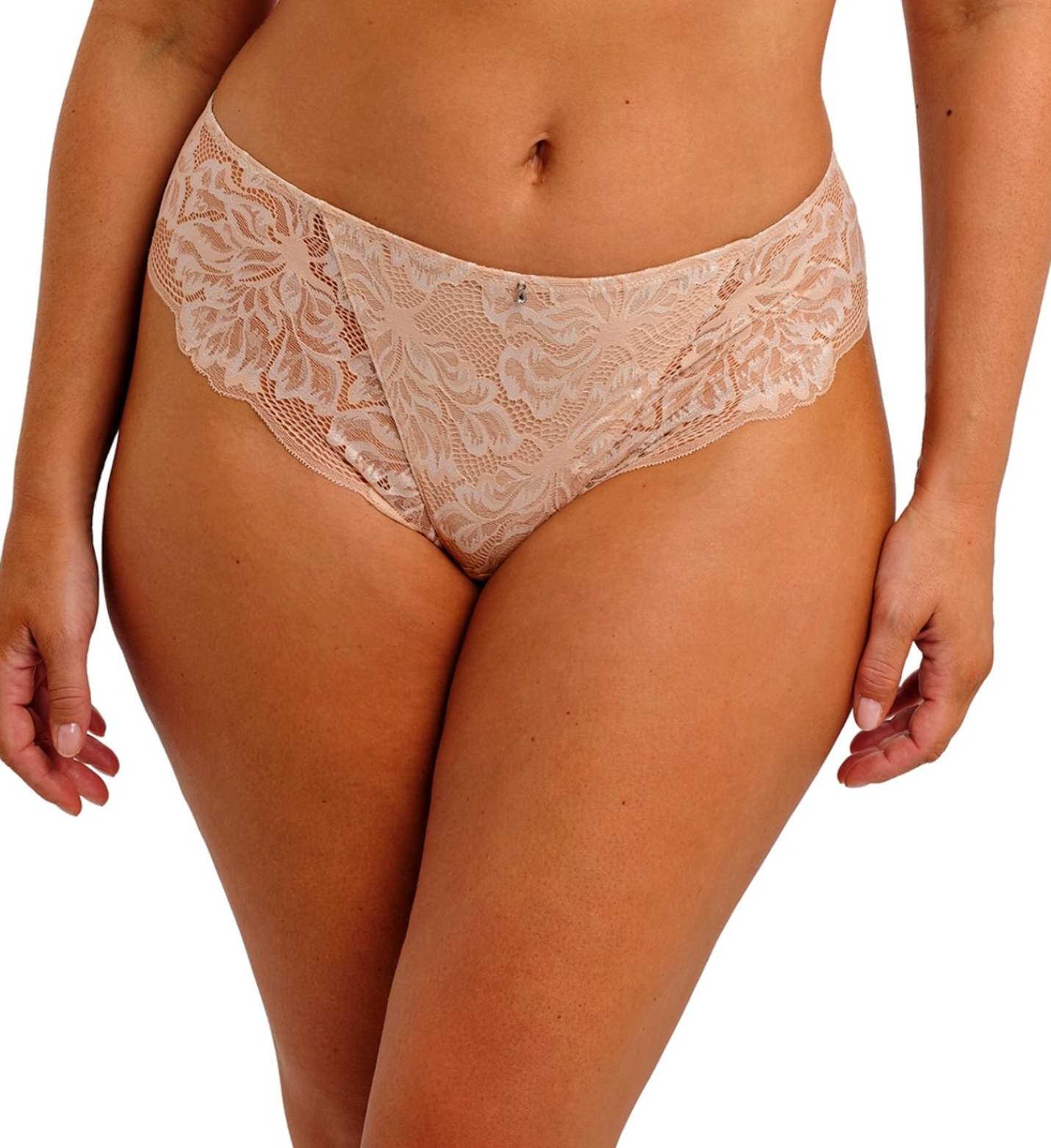 A close-up of a model wearing beige lace panties against a plain white background.