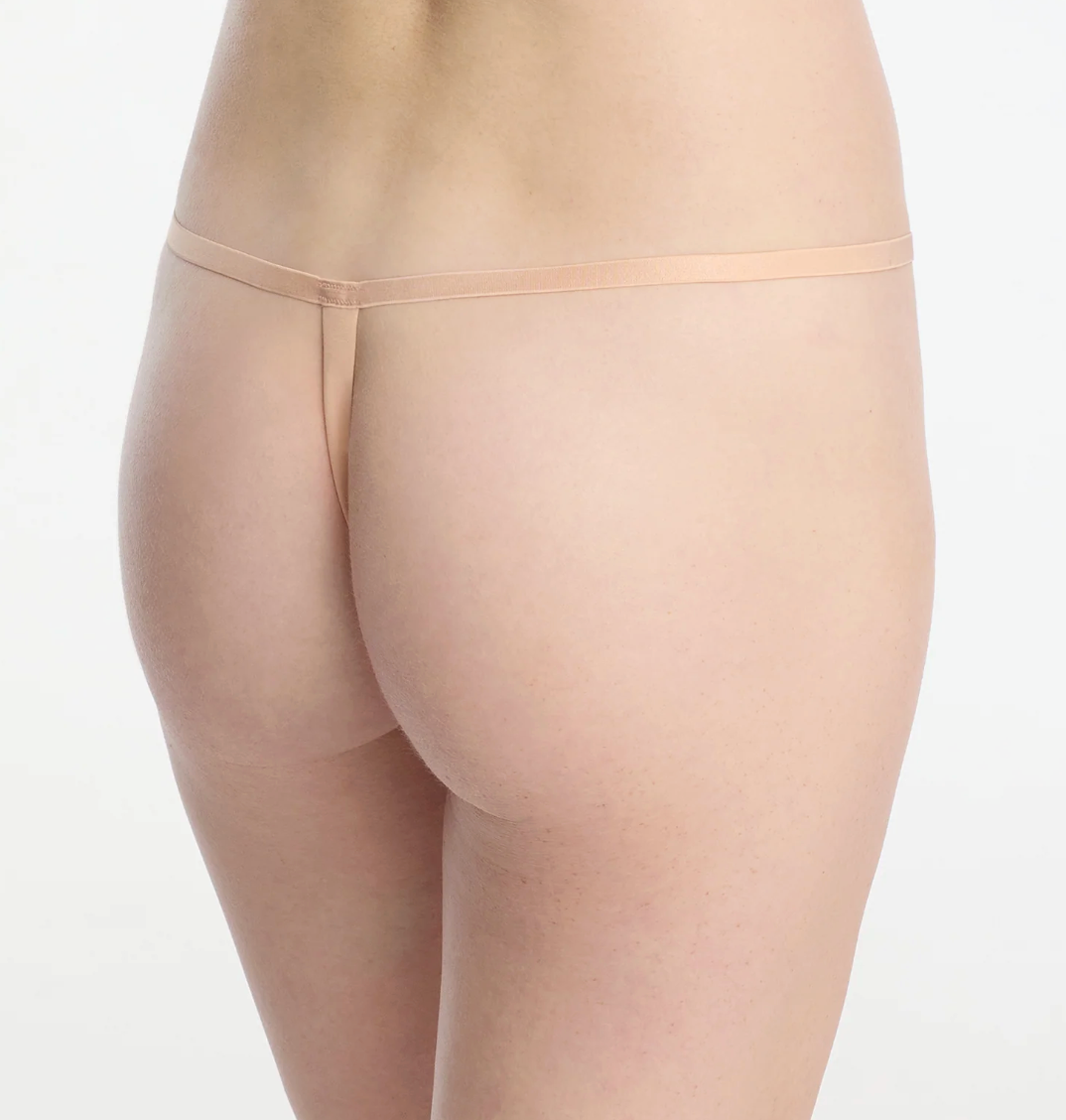 beige thong on model back