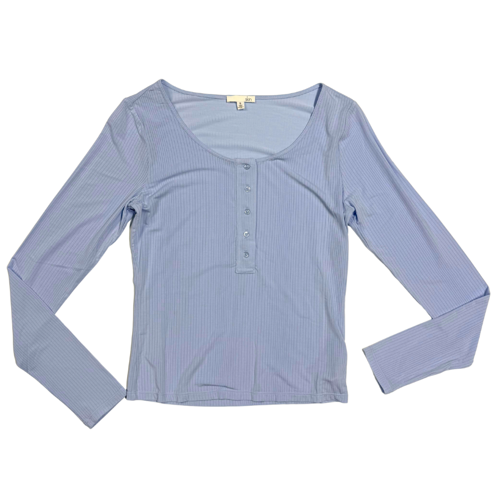 blue ribbed crop long sleeve with buttons down the center against a white background.