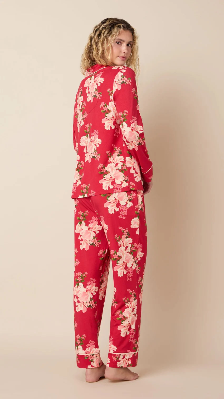 back of model wearing long floral pajamas against a neutral background 