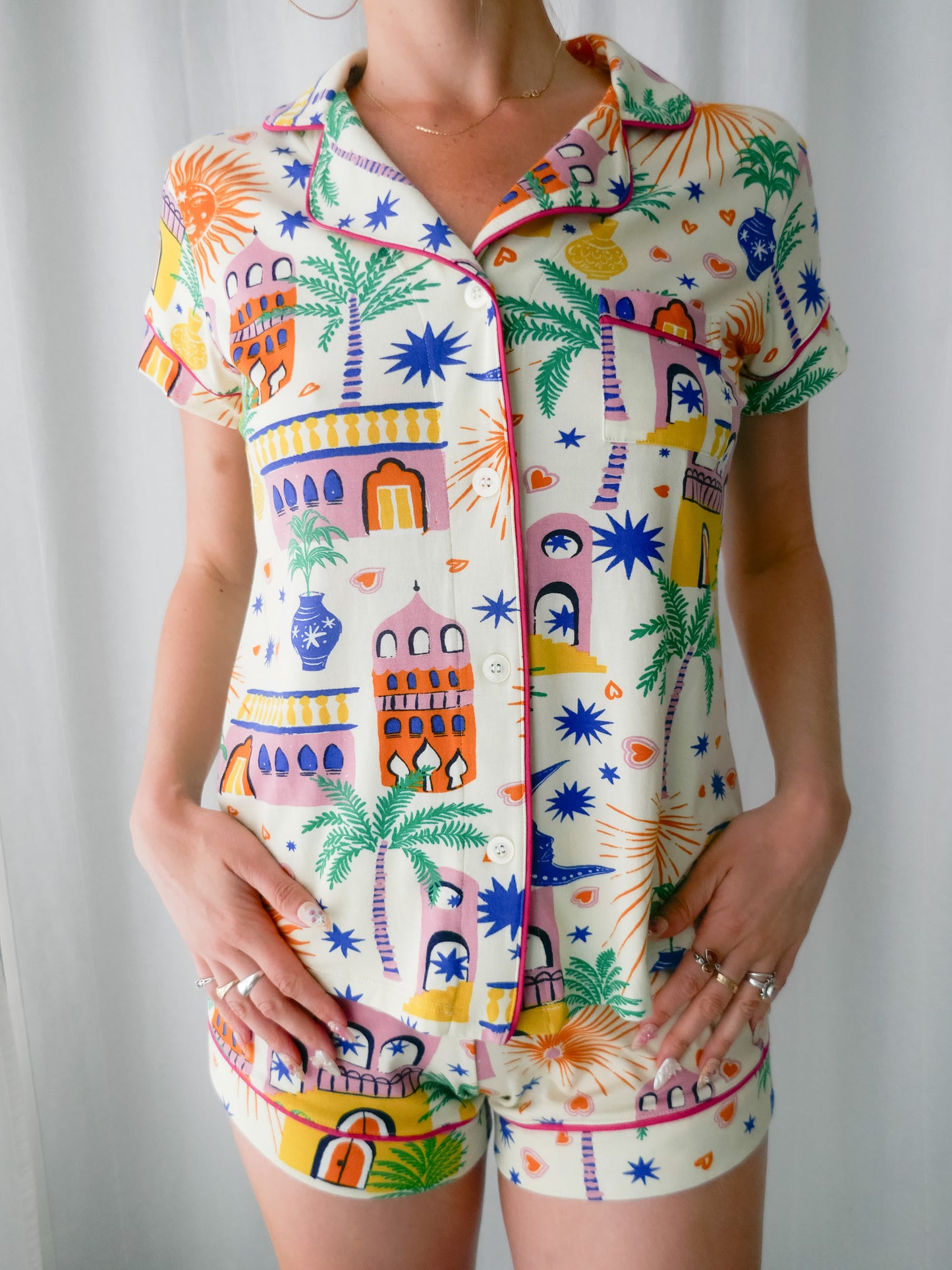Colorful patterned shirt and shorts set on a plain background