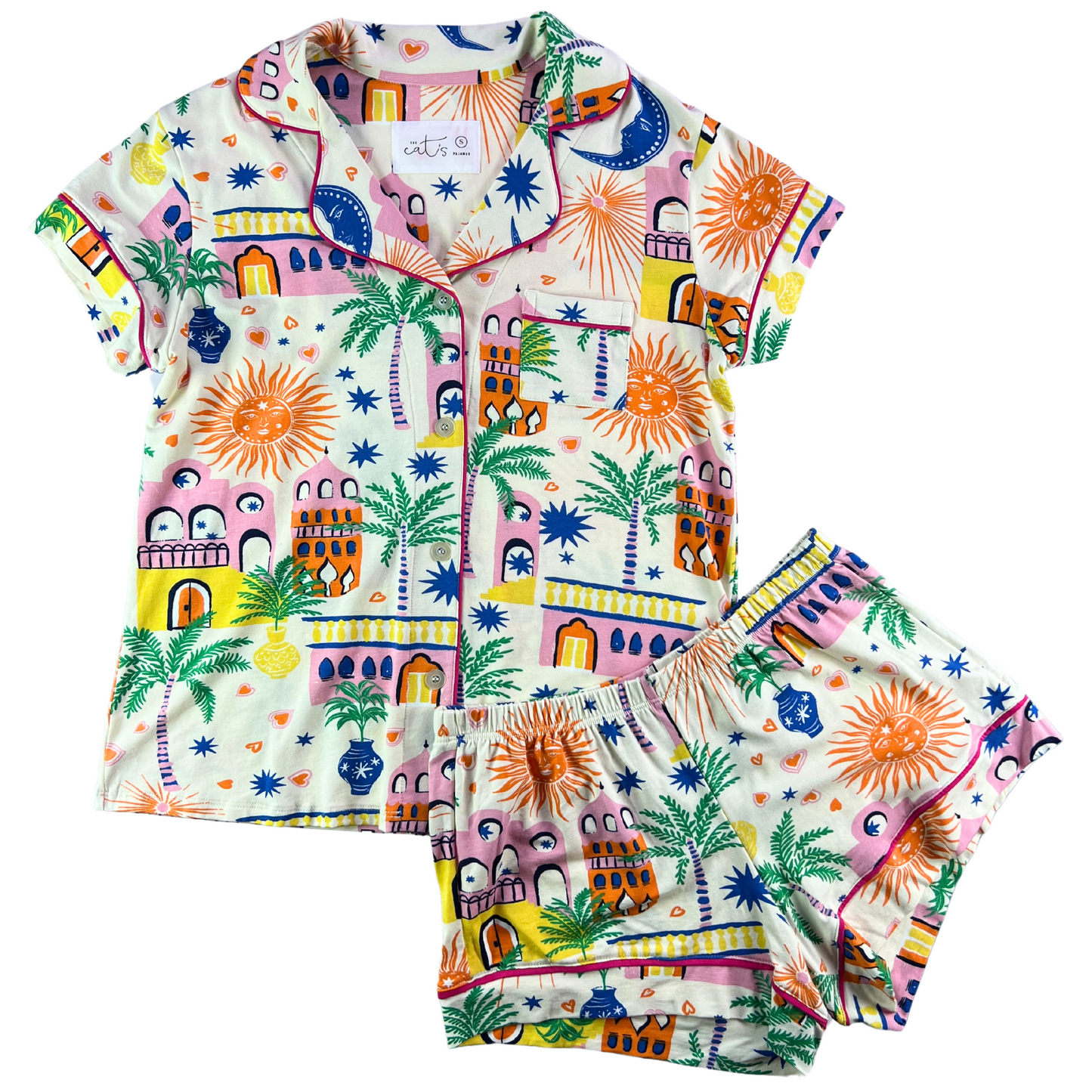 A short-sleeved button-down pajama top with a geometric pattern featuring palm trees and other motifs, paired with matching shorts.