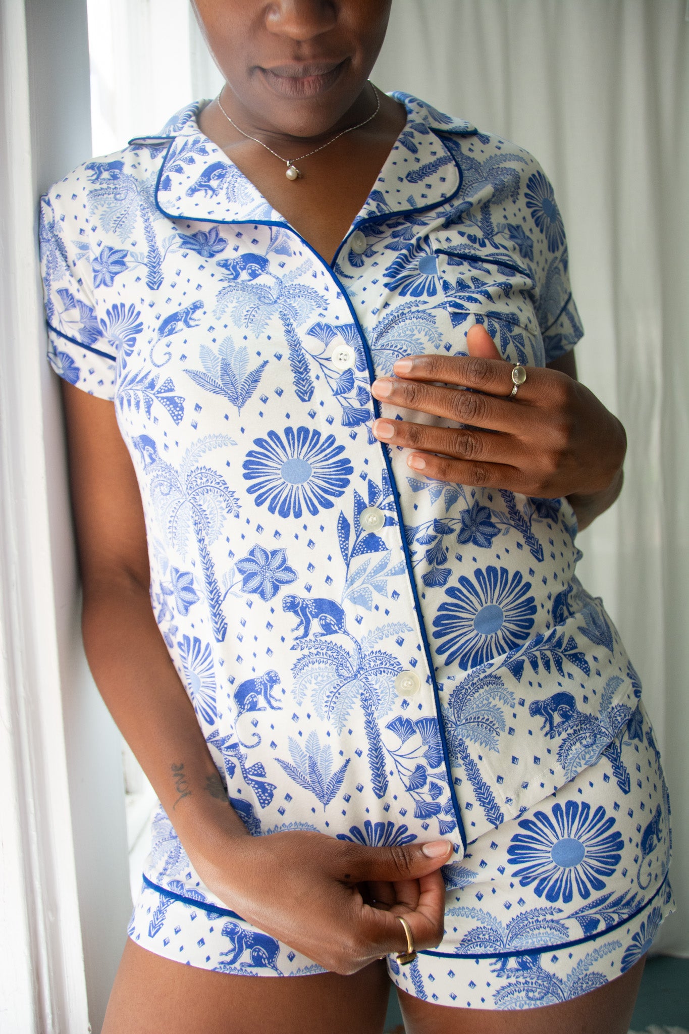 Person wearing a blue and white patterned outfit with a white background