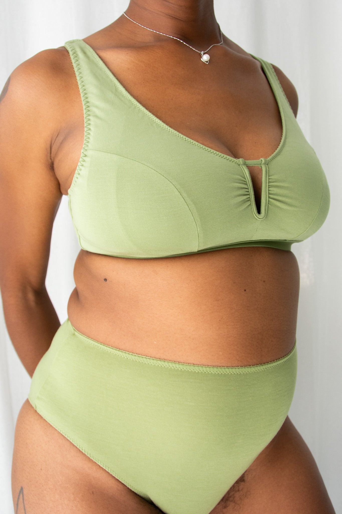 Person wearing a green bikini set against a plain background