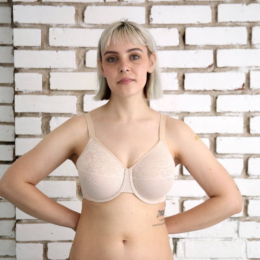 Wacoal Visual Effects Minimizer bra in sand, front close-up on a model against a brick wall.